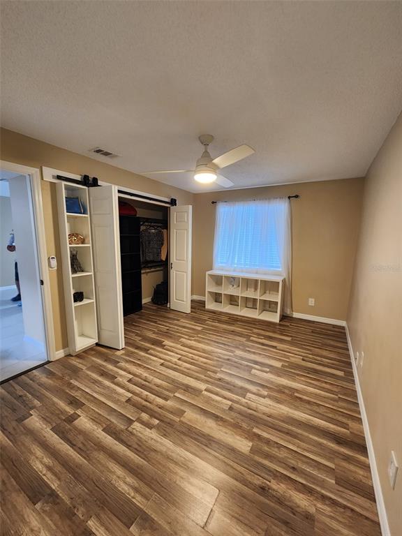 211 Thorntree Place Brandon, FL 33510 - Photo 10 of 16 a view of a kitchen with wooden floor and a ceiling fan