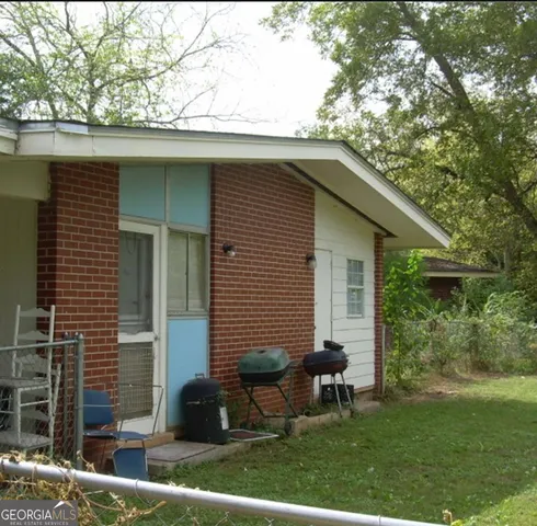 a backyard of a house with table and chairs