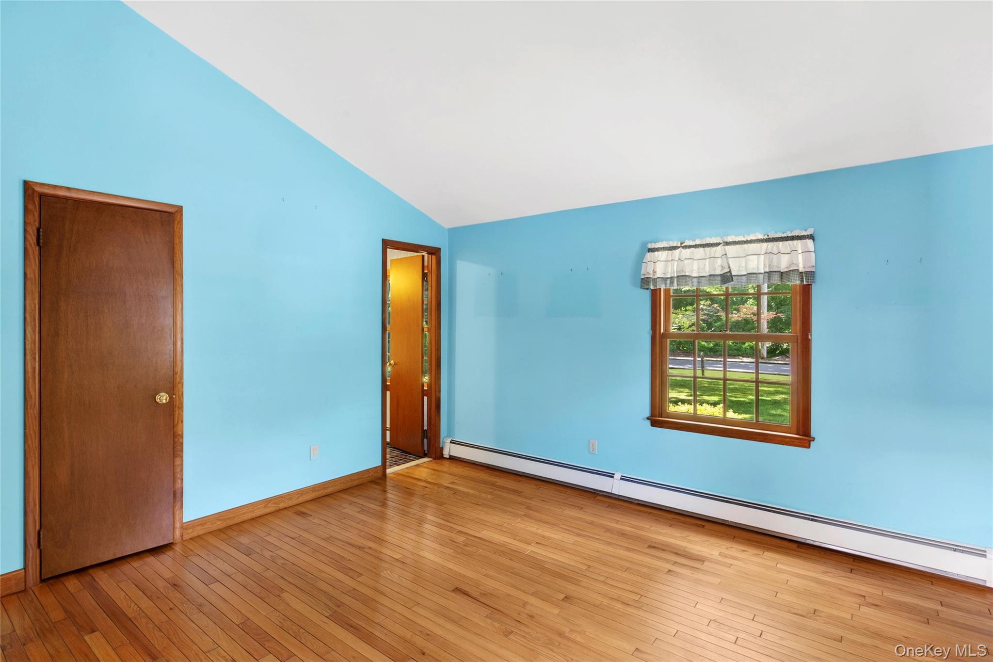 250 Paradise Point Road Southold, NY 11971 - Photo 14 of 24 an empty room with wooden floor closet and windows