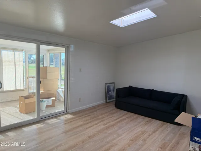 a living room with furniture and a floor to ceiling window