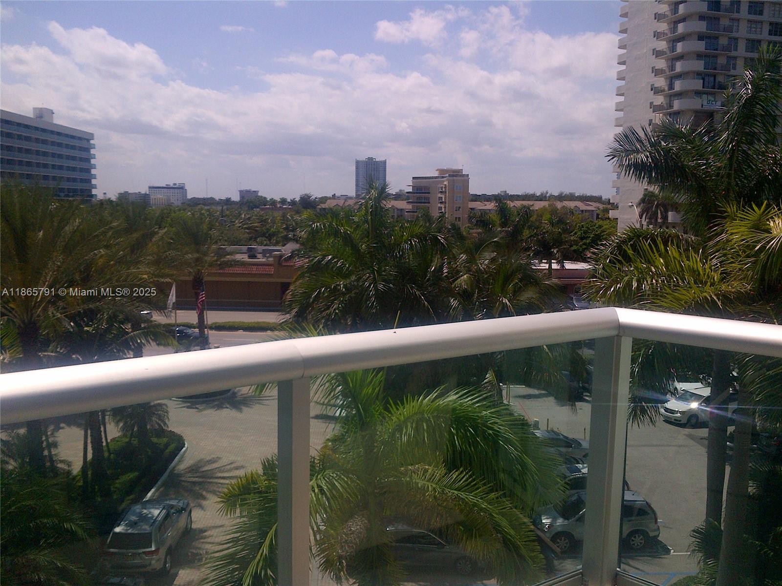 3901 South Ocean Drive, Unit 4U Hollywood, FL 33019 - Photo 4 of 8 a balcony with trees in front of it