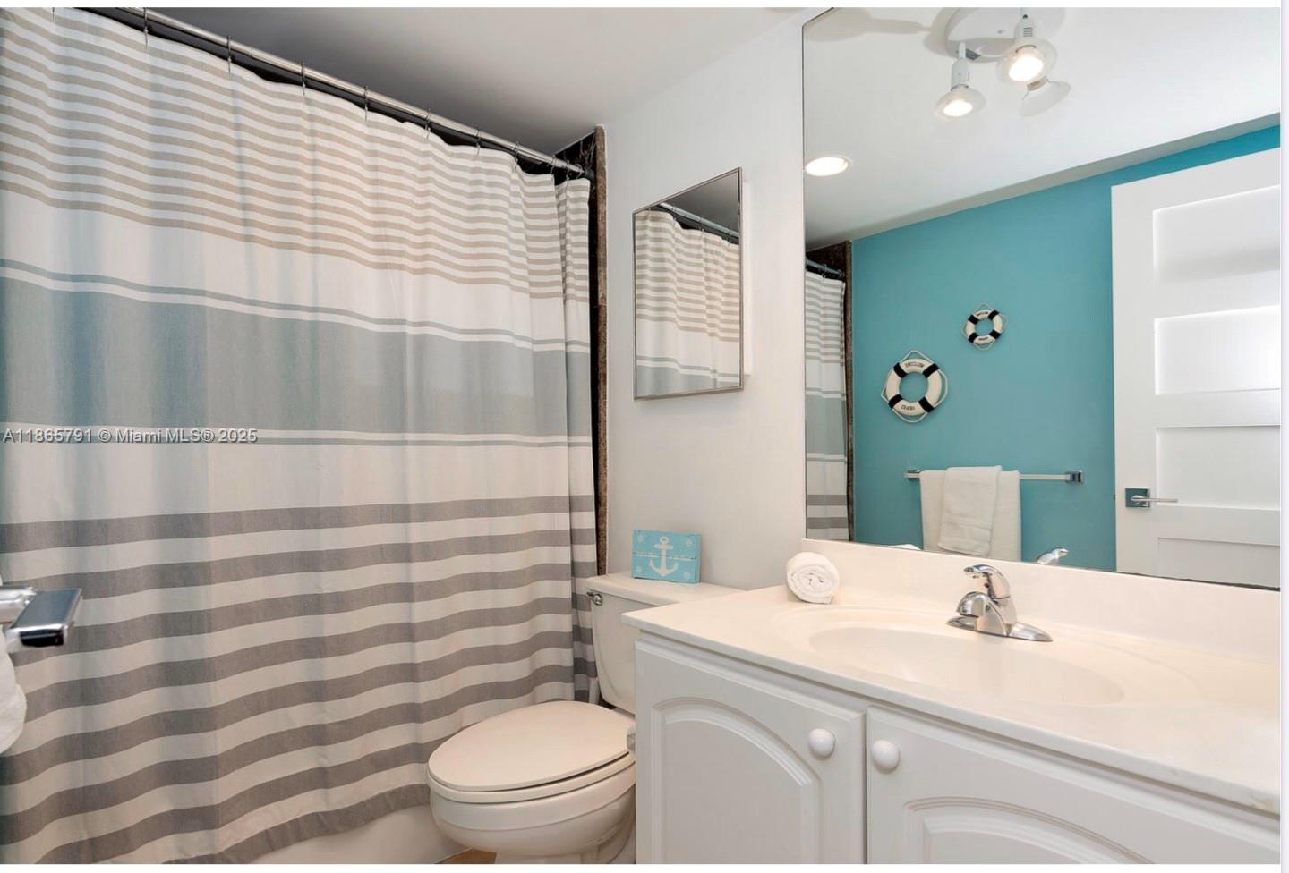 3901 South Ocean Drive, Unit 4U Hollywood, FL 33019 - Photo 8 of 8 a bathroom with a sink a toilet a shower and a mirror