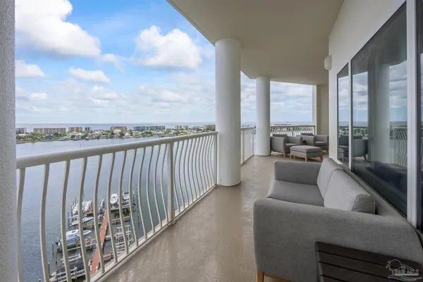 a view of an empty room with windows and balcony