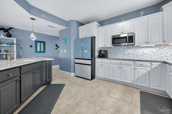 a kitchen with stainless steel appliances granite countertop a refrigerator sink and cabinets