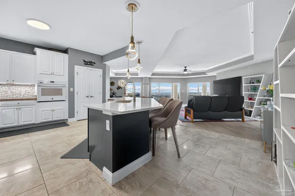 a kitchen with stainless steel appliances kitchen island granite countertop a refrigerator and a sink