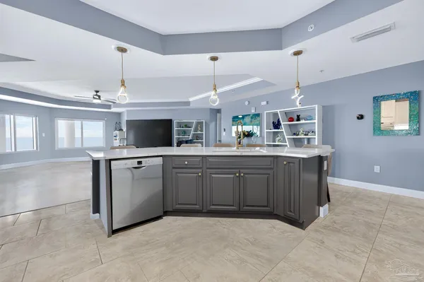 a kitchen with kitchen island granite countertop a sink counter top space appliances and a window