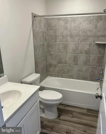 a bathroom with a toilet a sink and bathtub