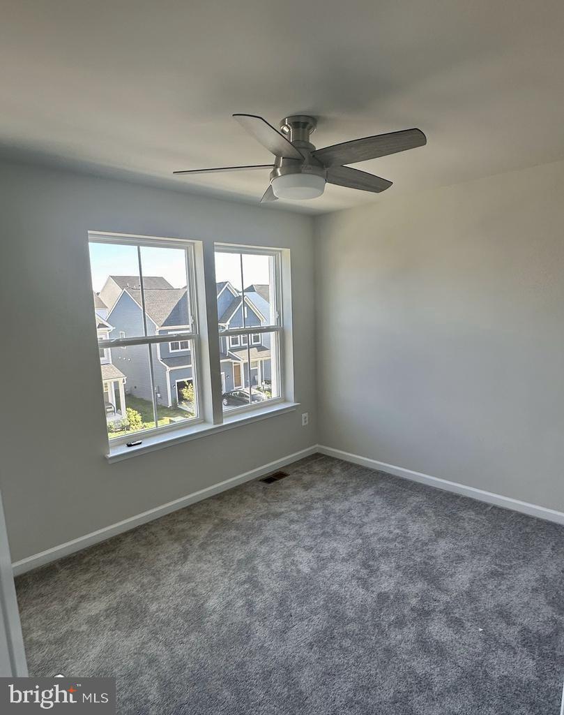 149 Swan Fld Avenue Ranson, WV 25438 - Photo 13 of 33 an empty room with windows and fan