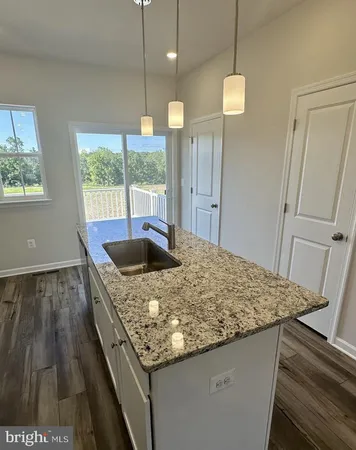 a kitchen with stainless steel appliances granite countertop sink stove and refrigerator