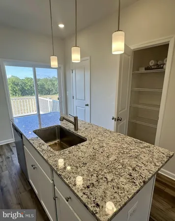 a kitchen with kitchen island a sink stove and refrigerator