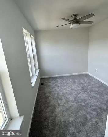 wooden floor in an empty room with a mirror