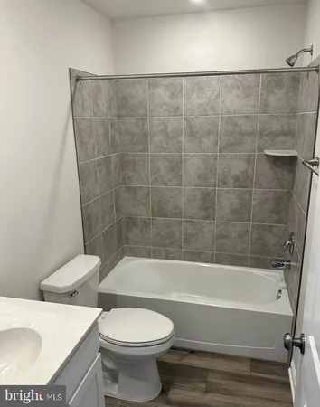 a bathroom with a toilet a sink and bathtub
