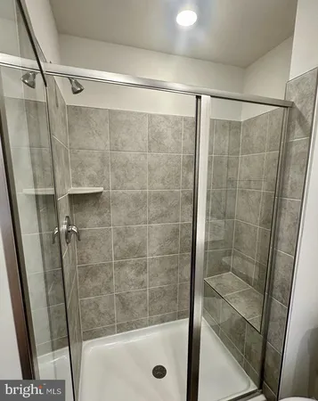 a bathroom with a glass door shower