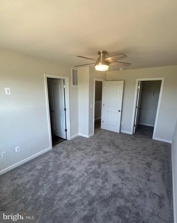 a view of a big room with closet and chandelier fan