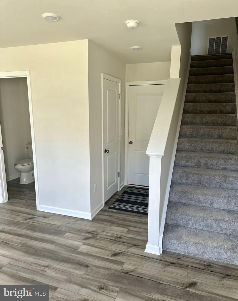 149 Swan Fld Avenue Ranson, WV 25438 - Photo 7 of 33 a view of a hallway with wooden floor and staircase