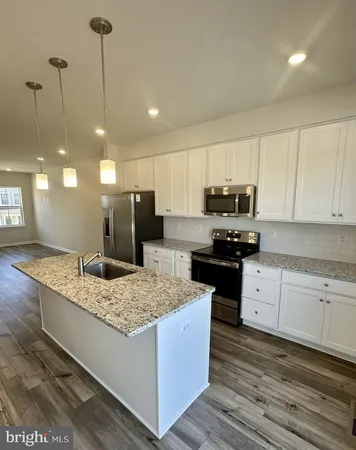 a kitchen with a sink stove and refrigerator