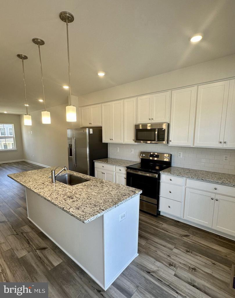 149 Swan Fld Avenue Ranson, WV 25438 - Photo 9 of 33 a kitchen with a sink stove and refrigerator