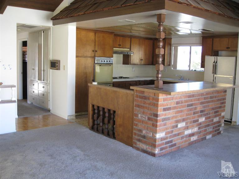 121 Santa Rosa Avenue Oxnard, CA 93035 - Photo 13 of 19 a kitchen with stainless steel appliances kitchen island granite countertop a refrigerator and a sink
