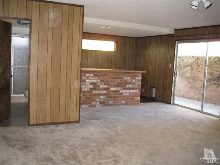 121 Santa Rosa Avenue Oxnard, CA 93035 - Photo 6 of 19 a view of an empty room with a fireplace and a window