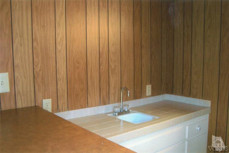 121 Santa Rosa Avenue Oxnard, CA 93035 - Photo 8 of 19 a view of a room with a wooden wall