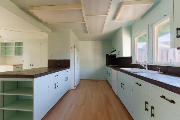 a kitchen with stainless steel appliances white cabinets and a refrigerator