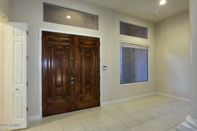 a view of a house with a small yard and large tree
