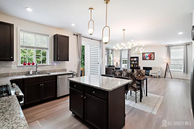 a large kitchen with kitchen island a sink table and chairs