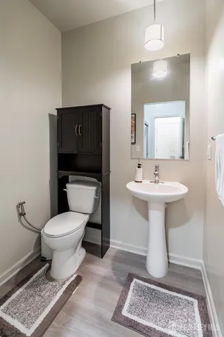 a bathroom with a sink toilet and a mirror