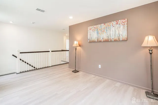 a view of a livingroom with wooden floor and a window