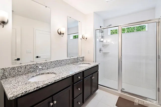 a bathroom with a granite countertop sink mirror and double