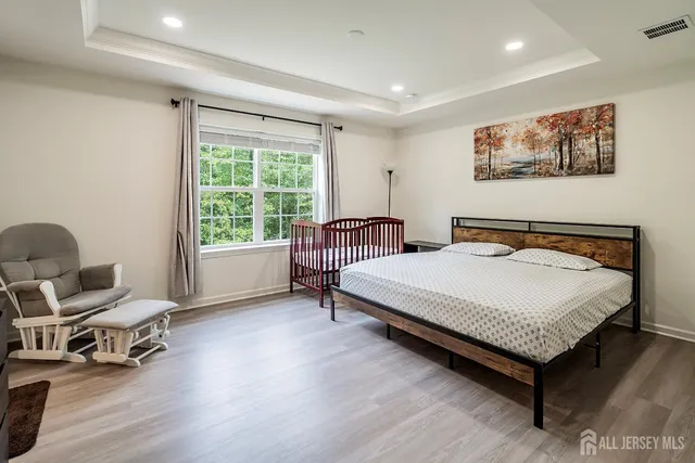 a bedroom with a bed and a large window