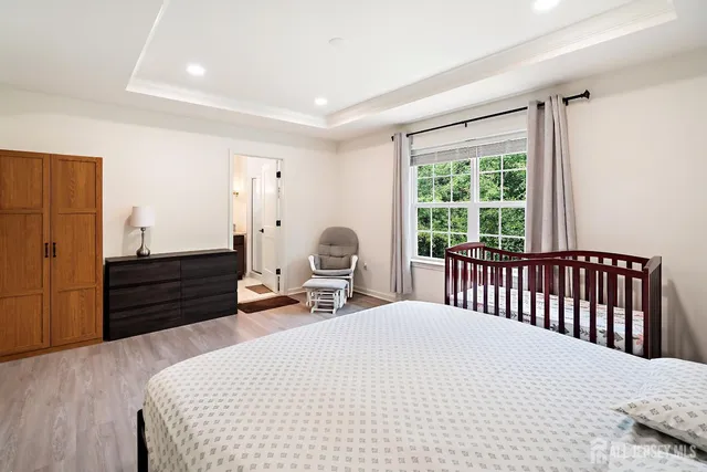 a bed room with a bed and a large window