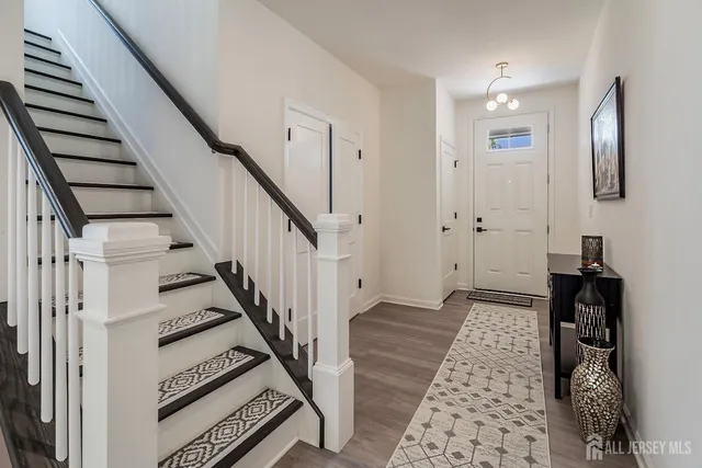 a view of a hallway with wooden floor and stairs