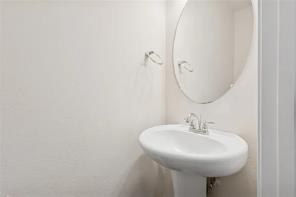 a bathroom with a sink a mirror and a toilet