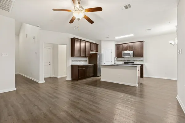 a view of kitchen with microwave and cabinets