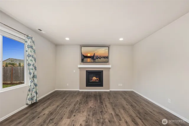 a view of an empty room window and fire place
