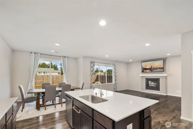 a living room with furniture a fireplace and a table