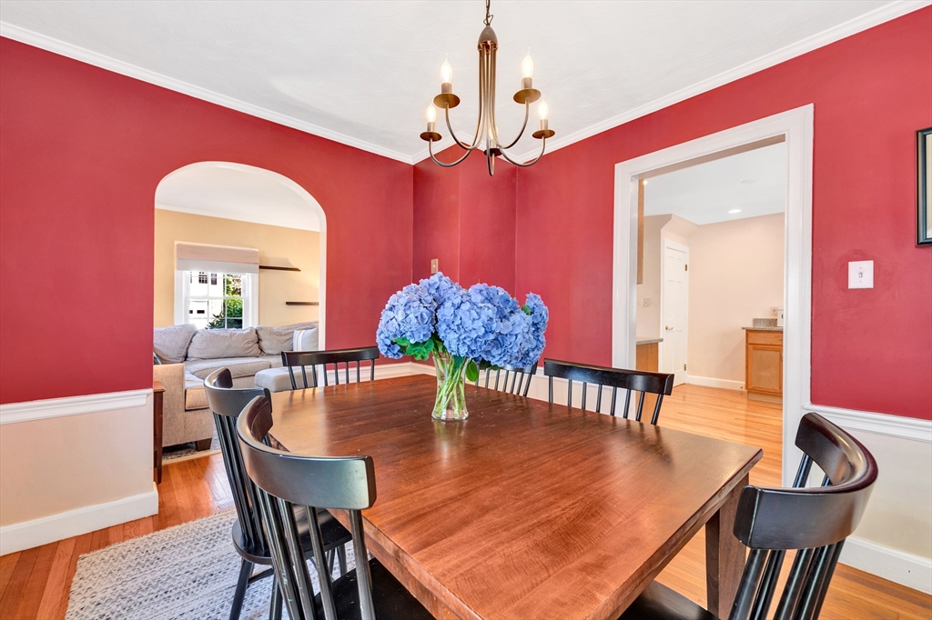 319 Appleton Street Arlington, MA 02476 - Photo 11 of 39 a dining room with furniture a chandelier and wooden floor