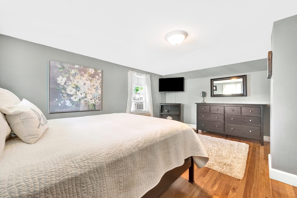 319 Appleton Street Arlington, MA 02476 - Photo 20 of 39 a bedroom with a large bed and a tv on dresser