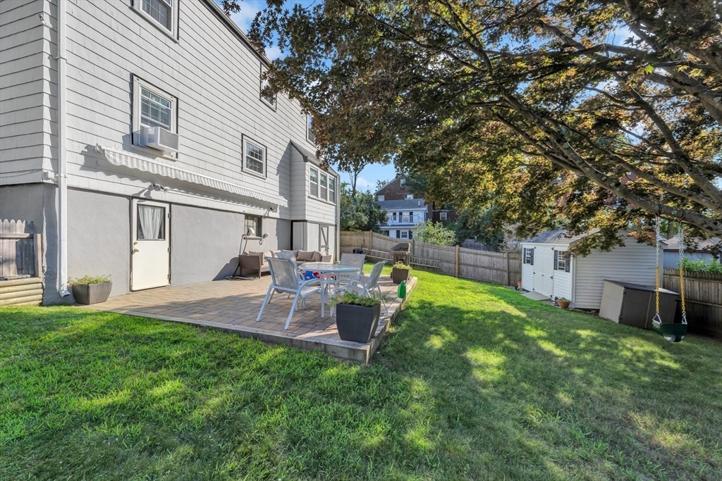 319 Appleton Street Arlington, MA 02476 - Photo 32 of 39 a view of a backyard with table and chairs and a large tree