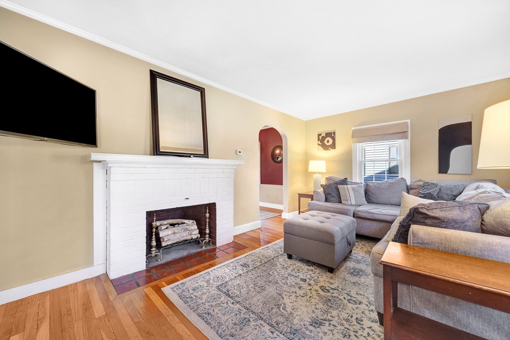 319 Appleton Street Arlington, MA 02476 - Photo 5 of 39 a living room with furniture and a fireplace