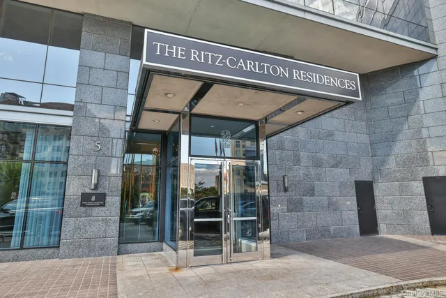 a living room with fireplace furniture and a view of kitchen