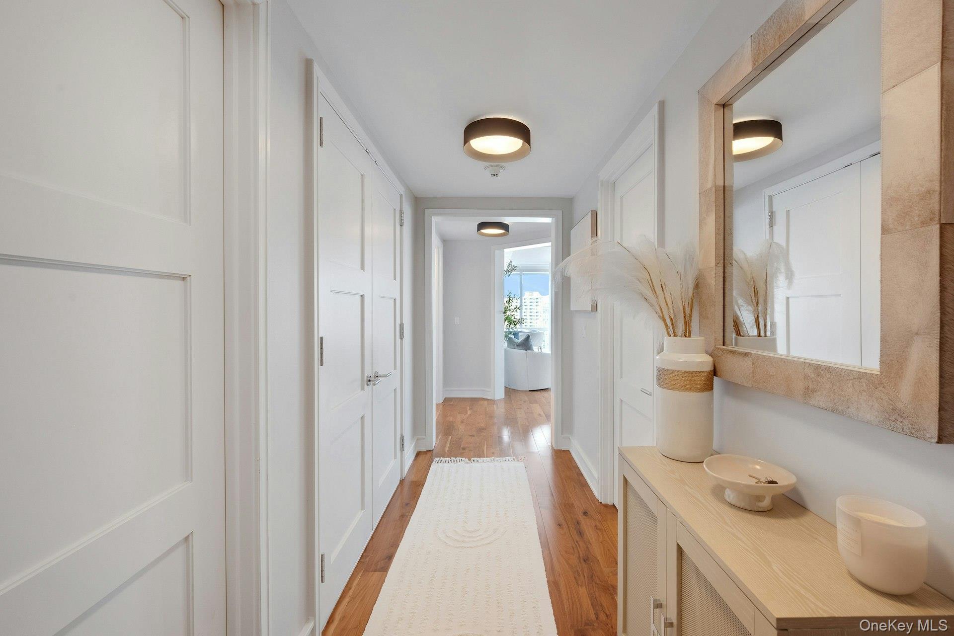 5 Renaissance Square, Unit 12A White Plains, NY 10601 - Photo 13 of 36 a bathroom with a sink and a mirror