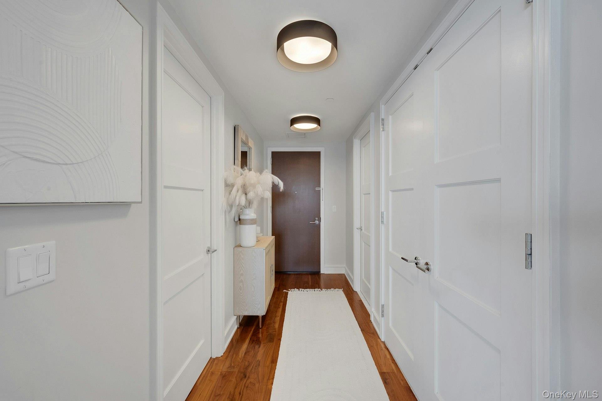 5 Renaissance Square, Unit 12A White Plains, NY 10601 - Photo 14 of 36 a view of a hallway with wooden floor