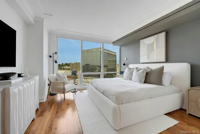 a bedroom with furniture and a flat screen tv