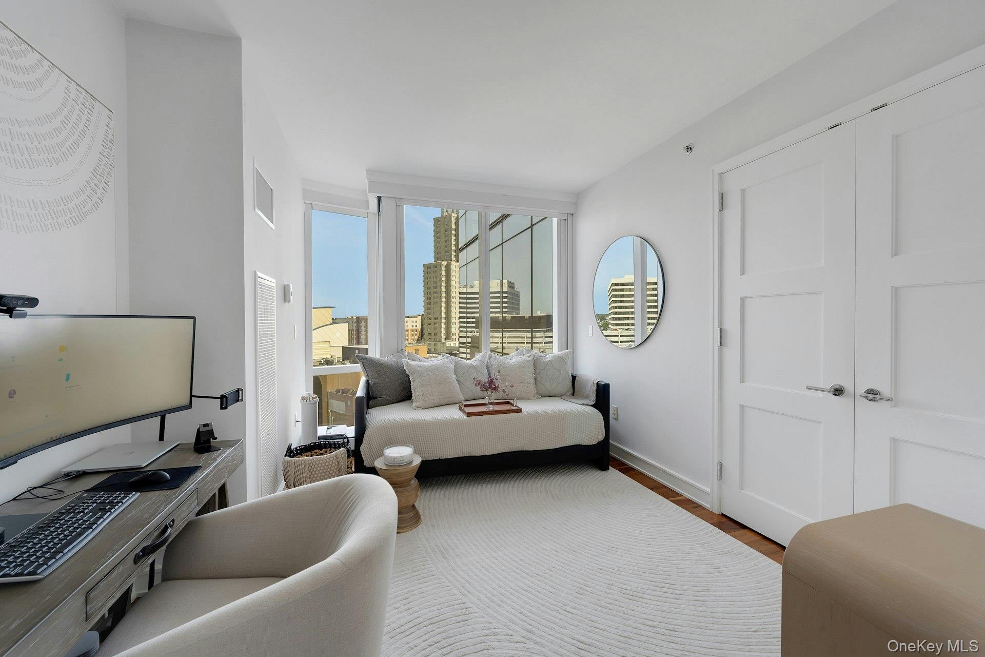 5 Renaissance Square, Unit 12A White Plains, NY 10601 - Photo 22 of 36 a living room with furniture and a flat screen tv
