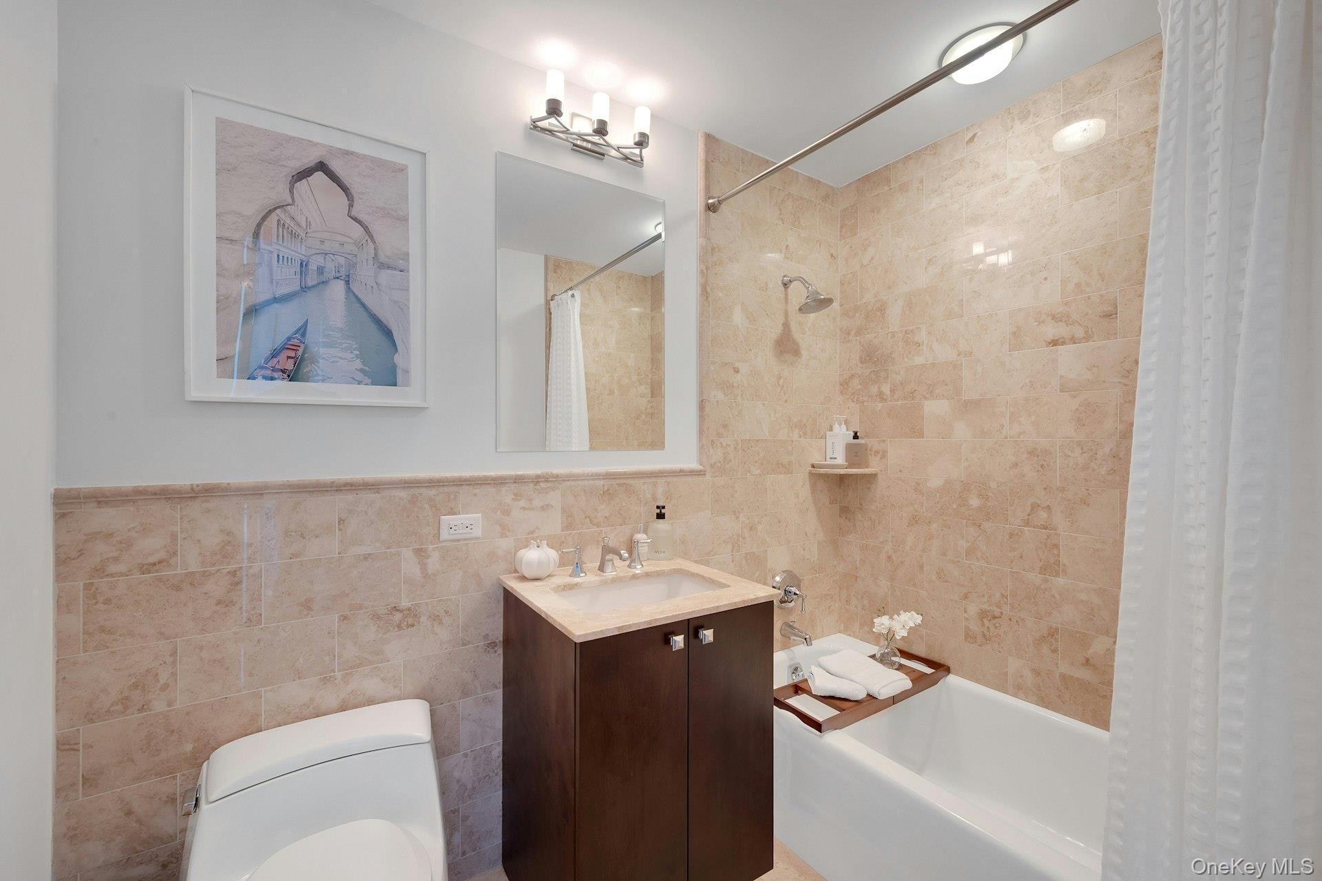 5 Renaissance Square, Unit 12A White Plains, NY 10601 - Photo 23 of 36 a bathroom with a sink a toilet and shower