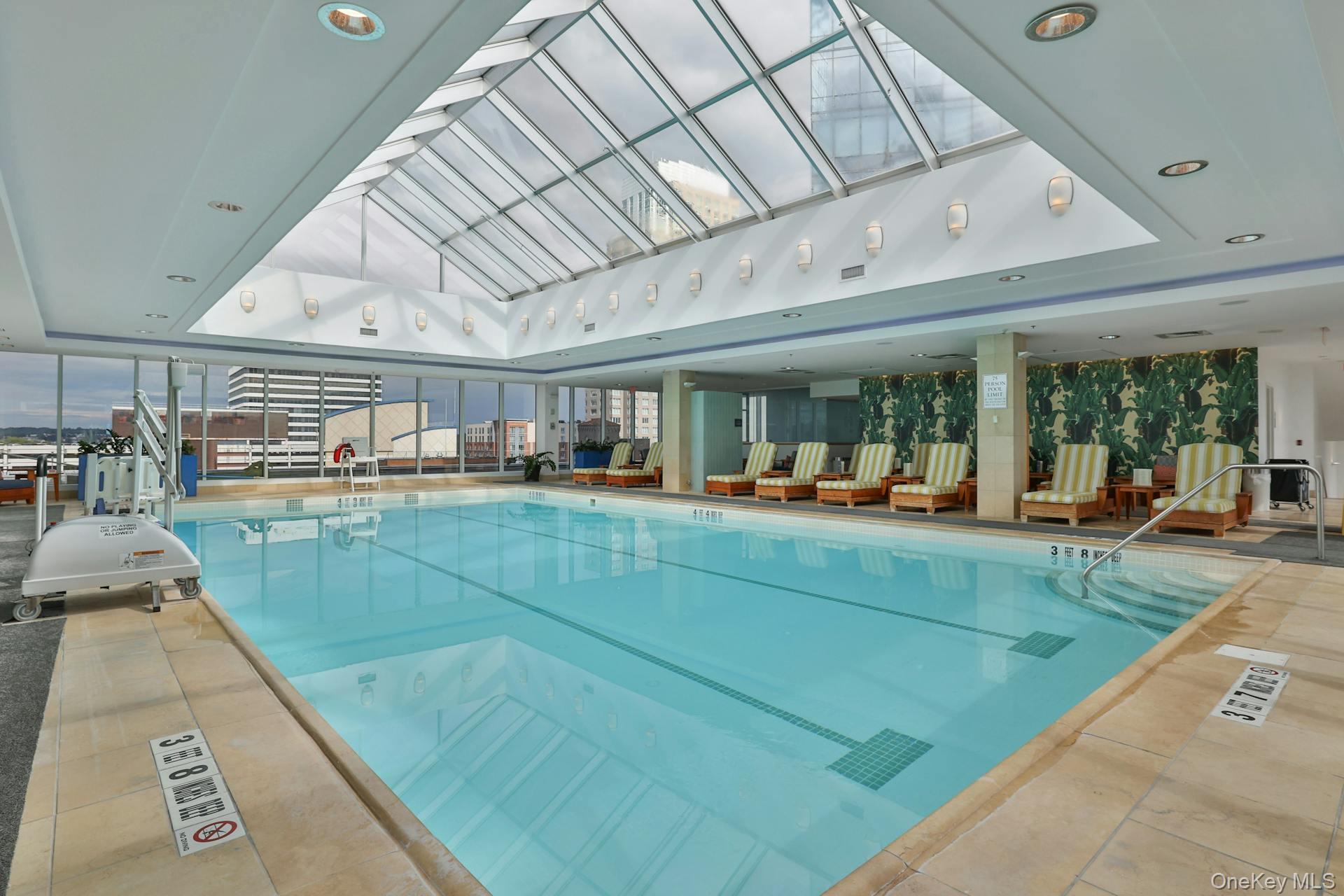 5 Renaissance Square, Unit 12A White Plains, NY 10601 - Photo 25 of 36 a living room with lots of furniture and a large window