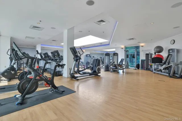 a room with gym equipment and large mirror