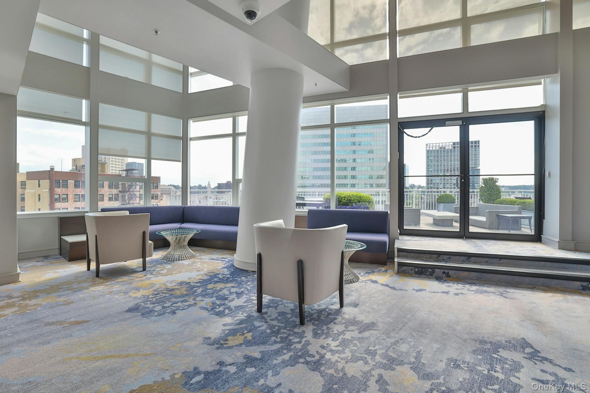 5 Renaissance Square, Unit 12A White Plains, NY 10601 - Photo 31 of 36 a living room with furniture and a floor to ceiling window